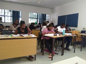 Learners writing in a classroom