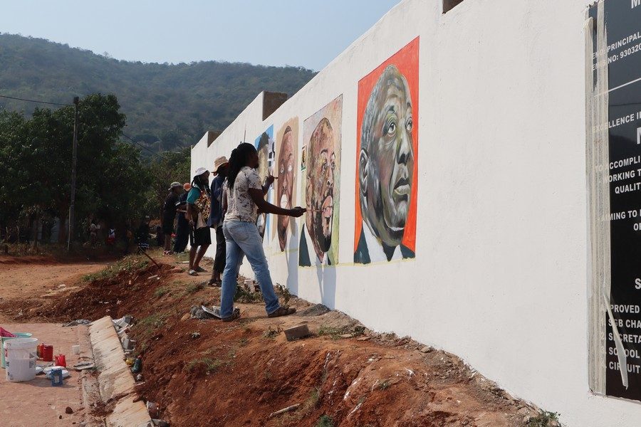 Artist working on a public mural