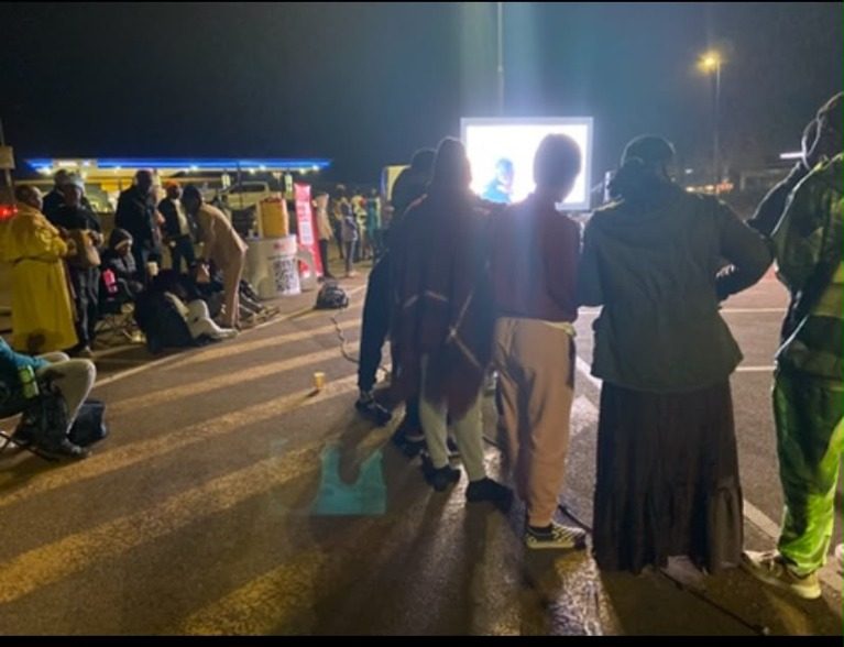 People at an outdoor evening event